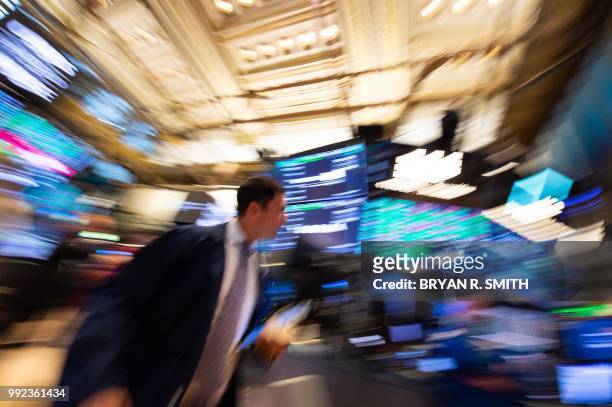 Traders work on the floor at the closing bell of the Dow Industrial Average at the New York Stock Exchange on July 5, 2018 in New York. / "The...