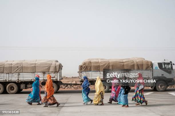Djiboutian women walk in front of Djibouti International Free Trade Zone in Djibouti on July 5, 2018.