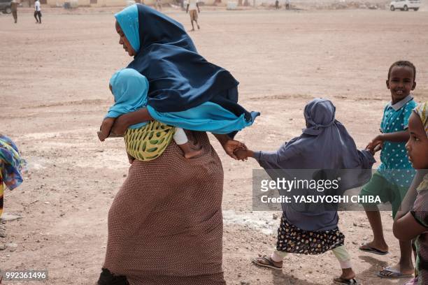 People leave after Djibouti's President Ismail Omar Guellehas attends the launching ceremony of new 1000-unit housing contruction project in...