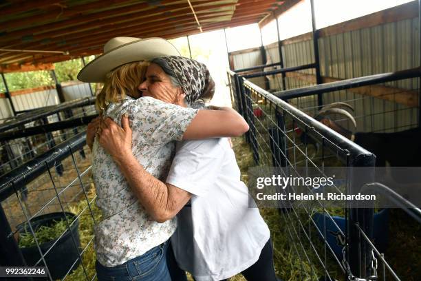 Veterinarian Dr. Romy Nicoletta, left, gives a hug to fire evacuee and goat owner Karen Bayci after checking on her goats at the Huerfano County...