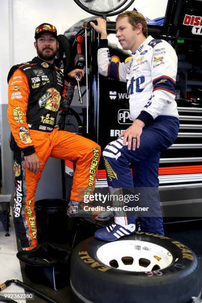 Martin Truex Jr., driver of the Bass Pro Shops/5-hour ENERGY Toyota, and Brad Keselowski, driver of the Stars Stripes and Lites Ford, talk during...