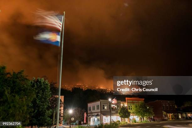 The streets of downtown Basalt were deserted late Wednesday night as the Lake Christine fire burns at the base of Basalt Mountain on July 4, 2018 in...