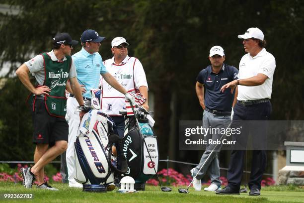 Phil Mickelson talks with his group on the 12th tee during round one of A Military Tribute At The Greenbrier held at the Old White TPC course on July...