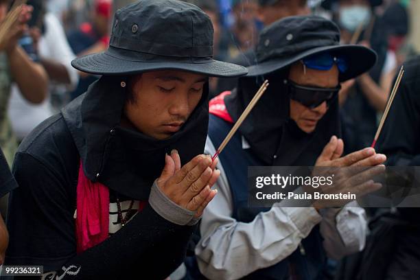 Anti-government Black Shirt Guards pray at a shrine on May 13, 2010 in central Bangkok, Thailand. The Black Shirt Guards are used as security forces...