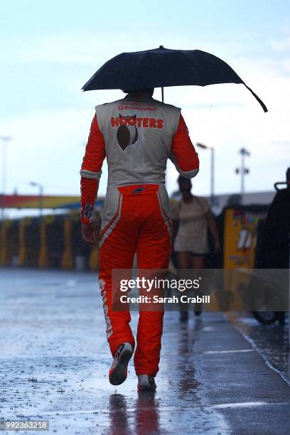 Chase Elliott, driver of the Hooters Chevrolet, walks through the garage area during practice for the Monster Energy NASCAR Cup Series Coke Zero...