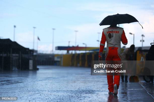 Chase Elliott, driver of the Hooters Chevrolet, walks through the garage area during practice for the Monster Energy NASCAR Cup Series Coke Zero...