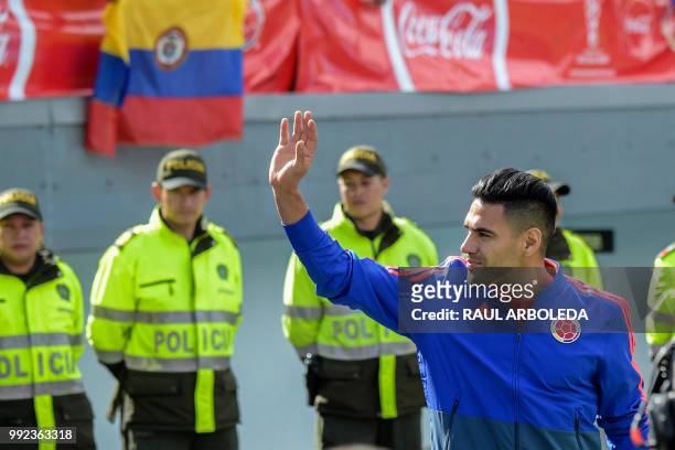 Colombian national team player Radamel Falcao waves to supporters during the welcoming ceremony of the team at El Campin stadium in Bogota on July 5...