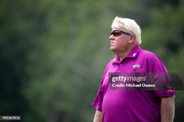 John Daly walks to his second shot on the 18th hole during round one of A Military Tribute At The Greenbrier held at the Old White TPC course on July...