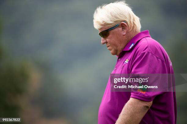 John Daly walks to his second shot on the 18th hole during round one of A Military Tribute At The Greenbrier held at the Old White TPC course on July...