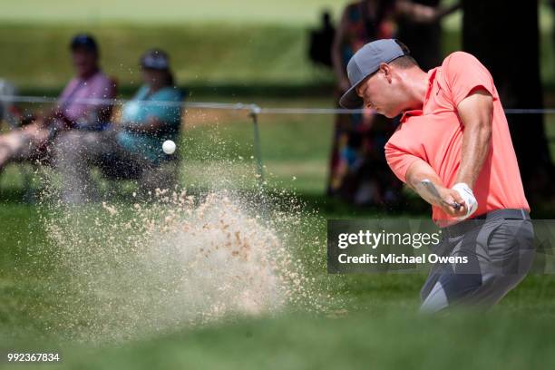 Keith Mitchell takes a shot out of the bunker on the 11th hole during round one of A Military Tribute At The Greenbrier held at the Old White TPC...
