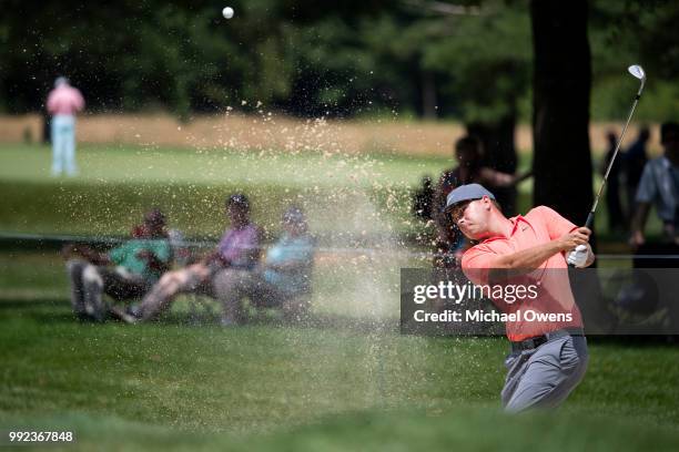 Keith Mitchell takes a shot out of the bunker on the 11th hole during round one of A Military Tribute At The Greenbrier held at the Old White TPC...