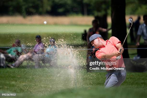 Keith Mitchell takes a shot out of the bunker on the 11th hole during round one of A Military Tribute At The Greenbrier held at the Old White TPC...