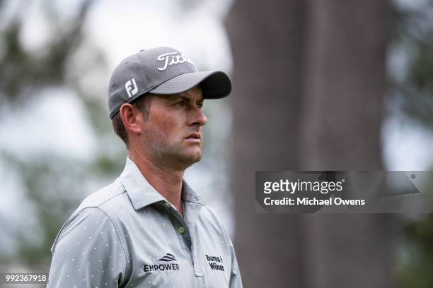 Webb Simpson walks to his second shot on the 12th hole during round one of A Military Tribute At The Greenbrier held at the Old White TPC course on...