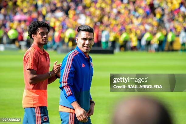 Colombian national team players Radamel Falcao and Juan Cuadrado enter the field during their welcoming ceremony at El Campin stadium in Bogota on...