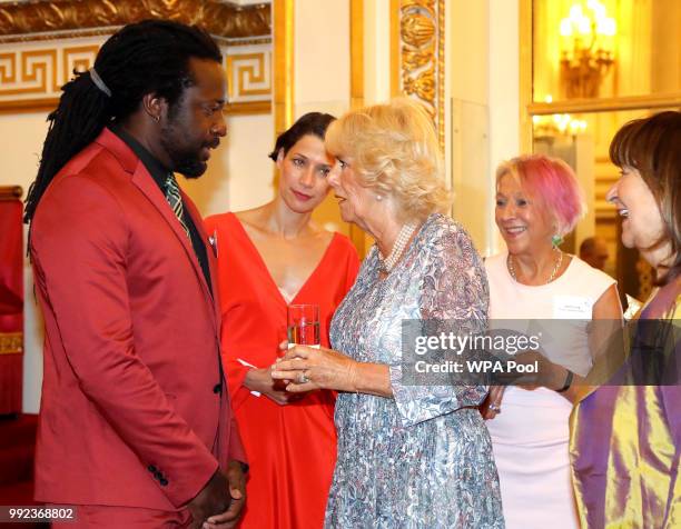 Camilla, Duchess of Cornwall meets winner Marlon James, as she attends a reception celebrating the 50th anniversary of the Man Booker Prize at...