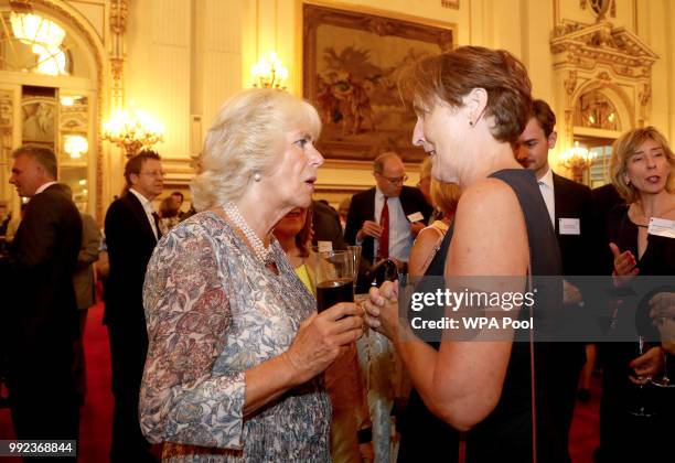 Camilla, Duchess of Cornwall meets Fiona Shaw, as she attends a reception celebrating the 50th anniversary of the Man Booker Prize at Buckingham...