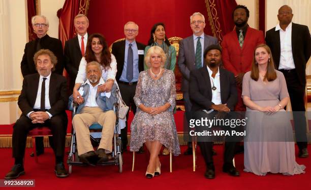 Camilla, Duchess of Cornwall poses for a picture with former Man Booker Prize winners Peter Carey, Julian Barnes, David Grossman , Kiran Desai, Alan...