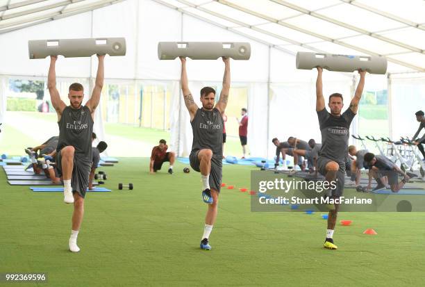 Calum Chambers, Carl Jenkinson and Aaron Ramsey of Arsenal during a training session at London Colney on July 5, 2018 in St Albans, England.