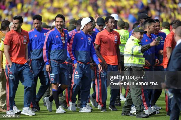 Colombian national team players enter the field during their welcoming ceremony at El Campin stadium in Bogota on July 5 after their participation in...