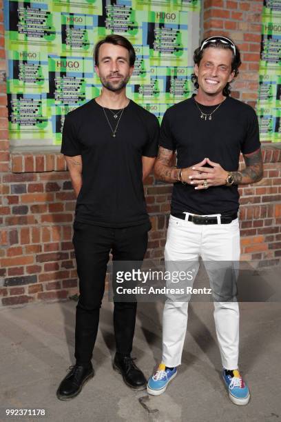 David Kurth Roth and Carl Jakob Haupt of Dandy Diary attend the HUGO show during the Berlin Fashion Week Spring/Summer 2019 at Motorwerk on July 5,...