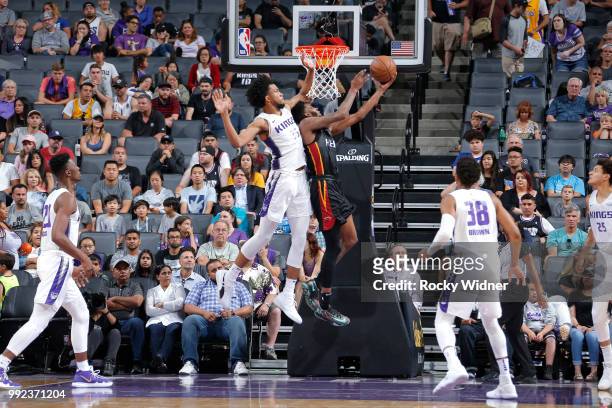 Derrick Jones Jr. #5 of the Miami Heat goes to the basket against Marvin Bailey III of the Sacramento Kings during the 2018 Summer League at the...