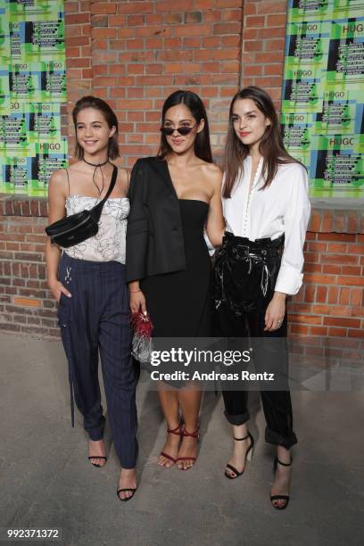 Lisa-Marie Koroll, Nilam Farooq and Luise Befort attend the HUGO show during the Berlin Fashion Week Spring/Summer 2019 at Motorwerk on July 5, 2018...