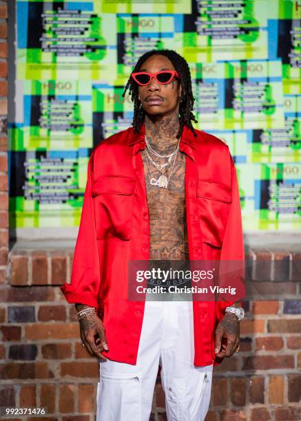 Wiz Khalifa wearing red jacket, white pants seen at HUGO during the Berlin Fashion Week July 2018 on July 5, 2018 in Berlin, Germany.