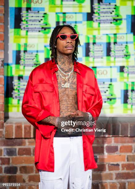 Wiz Khalifa wearing red jacket, white pants seen at HUGO during the Berlin Fashion Week July 2018 on July 5, 2018 in Berlin, Germany.