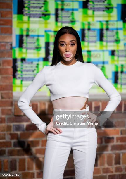 Winnie Harlow wearing white cropped top, white pants is seen at HUGO during the Berlin Fashion Week July 2018 on July 5, 2018 in Berlin, Germany.