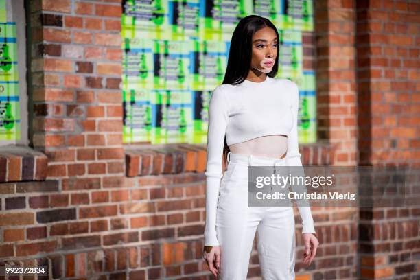 Winnie Harlow wearing white cropped top, white pants is seen at HUGO during the Berlin Fashion Week July 2018 on July 5, 2018 in Berlin, Germany.