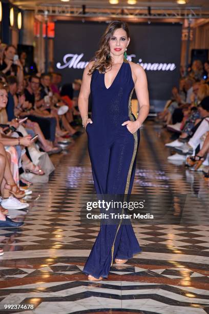 Daniela Dany Michalski walks the runway at the Fashion2Show show during the Berlin Fashion Week Spring/Summer 2019 at Quartier 206 on July 5, 2018 in...