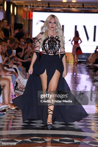 Jessica Neufeld walks the runway at the Fashion2Show show during the Berlin Fashion Week Spring/Summer 2019 at Quartier 206 on July 5, 2018 in...