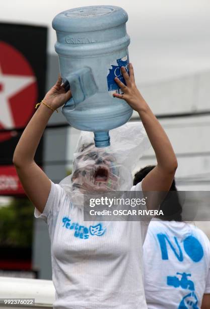 Woman takes part in a march against a water privatization bill under consideration of lawmakers in San Salvador, on July 5, 2018.