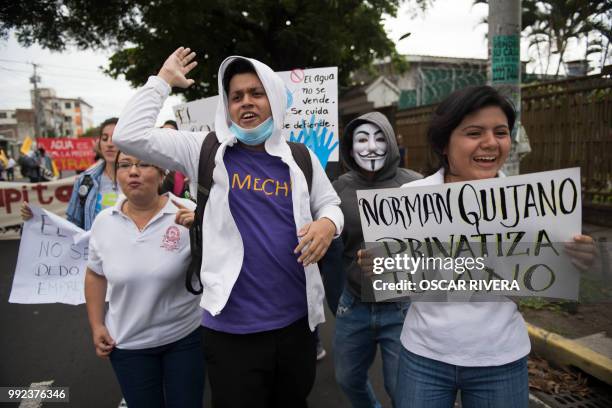 People march against a water privatization bill under consideration of lawmakers in San Salvador, on July 5, 2018.