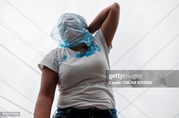 Woman takes part in a march against a water privatization bill under consideration of lawmakers in San Salvador, on July 5, 2018.