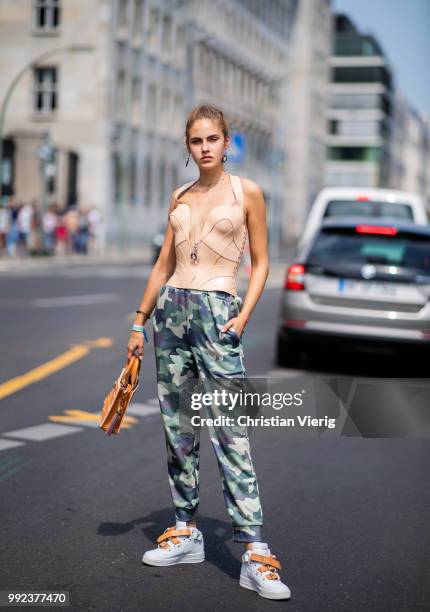 Model Elena Carriere wearing pants with camouflage print is seen outside Marina Hoermanseder during the Berlin Fashion Week July 2018 on July 5, 2018...
