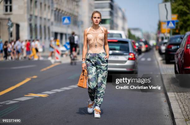 Model Elena Carriere wearing pants with camouflage print is seen outside Marina Hoermanseder during the Berlin Fashion Week July 2018 on July 5, 2018...