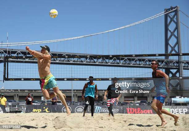 Christian Honer hits the ball, as his partner Ryan Meehan looks on, during their match against Bruno Amorim and Chris Luers during Day 1 of the AVP...