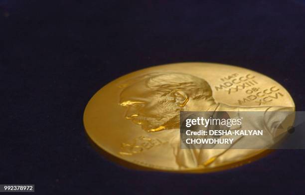 In this file photo taken on May 07, 2005 the gold replica of the Nobel medal is on display during the function of the Replacement of the Nobel...