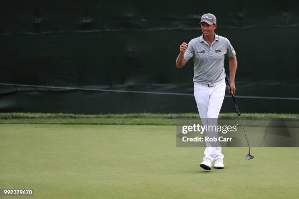 Webb Simpson reacts after finishing on the 18th green during round one of A Military Tribute At The Greenbrier held at the Old White TPC course on...