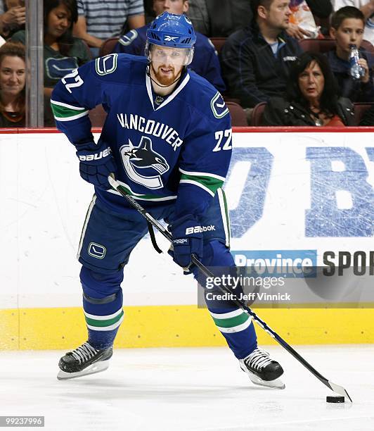 Daniel Sedin of the Vancouver Canucks skates up ice with the puck in Game 6 of the Western Conference Semifinals against the Chicago Blackhawks...