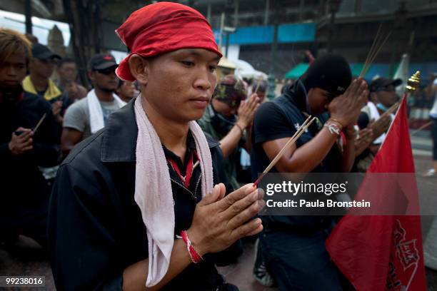 Anti-government Black Shirt Guards pray at a shrine on May 13, 2010 in central Bangkok, Thailand. The Black Shirt Guards are used as security forces...
