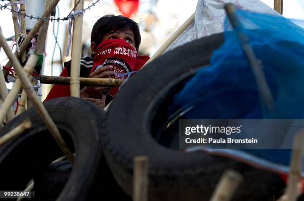 An anti-government protester mans a barricade on May 13, 2010 in central Bangkok, Thailand. The Black Shirt Guards are used as security forces for...