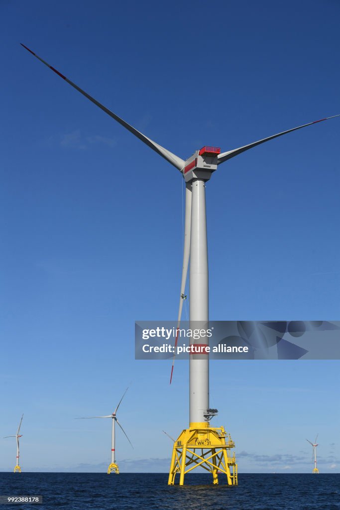 Wind turbine technicians check an offshore wind turbine at the Baltic ...