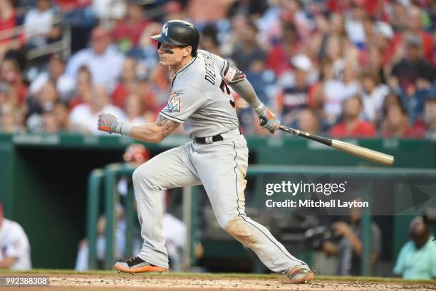 Derek Dietrich of the Miami Marlins singles in the second inning during a baseball game against the Washington Nationals at Nationals Park on July 5,...