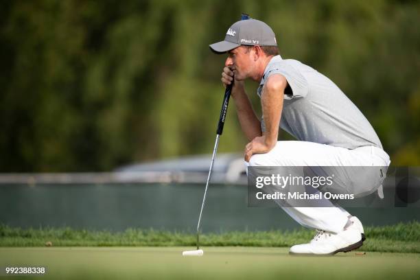 Webb Simpson lines up his putt on the 16th hole during round one of A Military Tribute At The Greenbrier held at the Old White TPC course on July 5,...