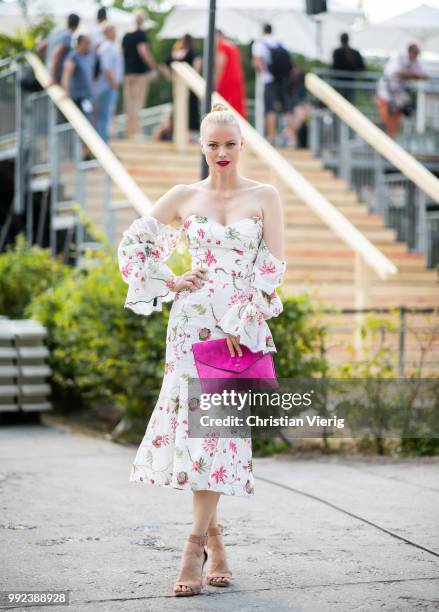Model Franziska Knuppe wearing off shoulder dress Lana Mueller, pink clutch is seen outside Lana Mueller during the Berlin Fashion Week July 2018 on...