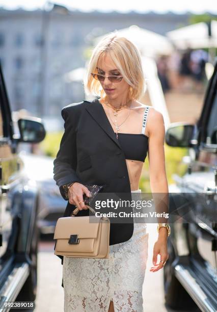 Viktoria Rader wearing white sheer skirt, Dior cropped top, Chanel bag is seen outside Lana Mueller during the Berlin Fashion Week July 2018 on July...