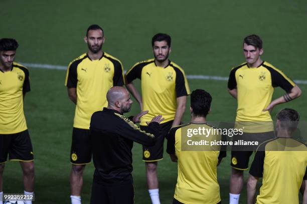 Borussia Dortmund's Head Coach Peter Bosz gives instructions to his players during a training session ahead of the UEFA Champions League Group H...