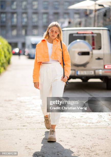 Alessa Winter wearing orange cropped denim jacket is seen outside Lana Mueller during the Berlin Fashion Week July 2018 on July 5, 2018 in Berlin,...